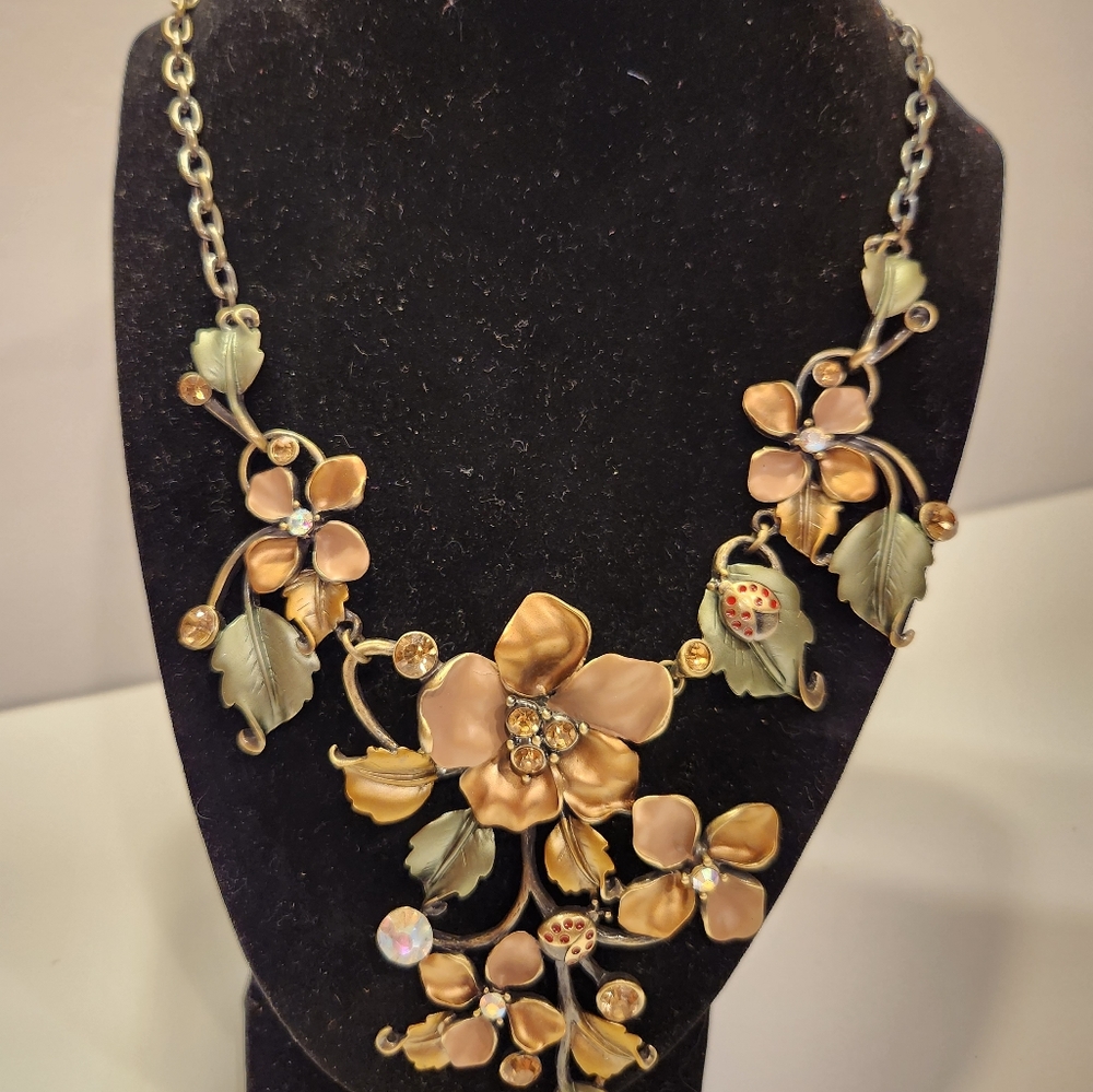 Bold bronze colored floral pattern necklace. Silver tone extension